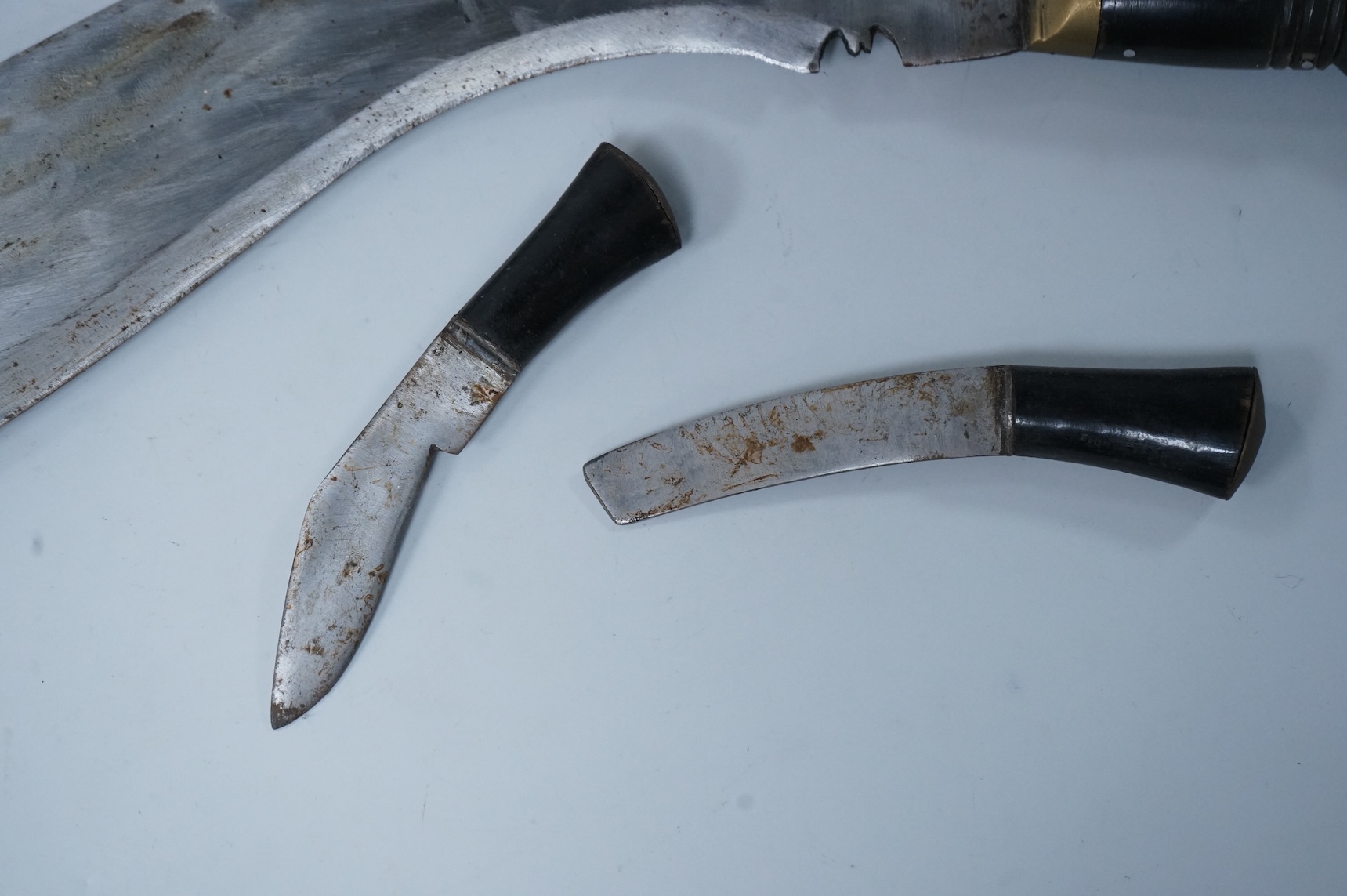 Two kukri knives in leather covered scabbards